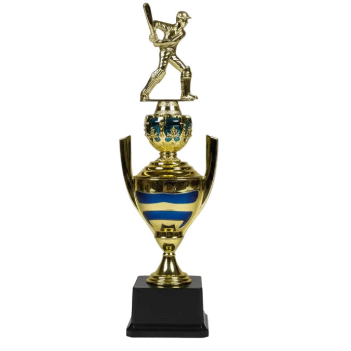 Gold trophy with a baseball player figure on top, placed on a chair.