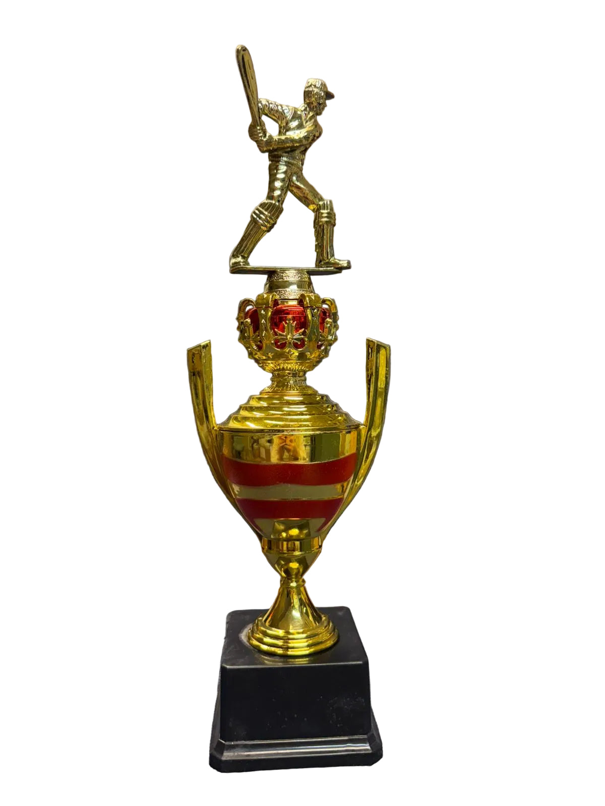 Gold trophy with a cricket player figure on top, placed on a chair.