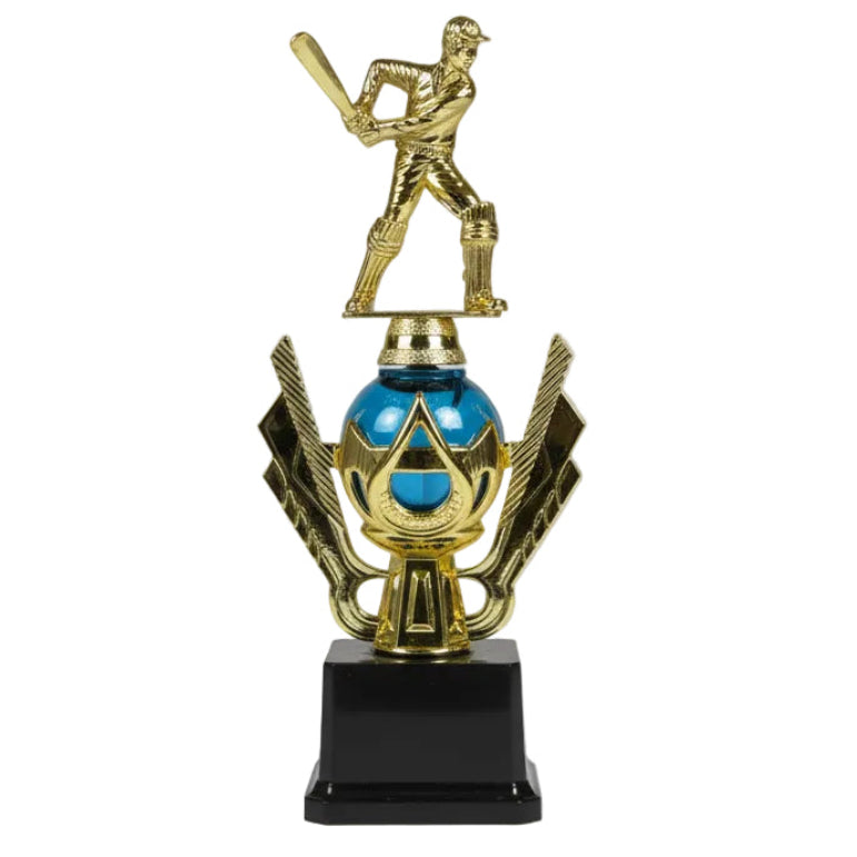 Gold trophy with a baseball player figure on top, placed on a chair.