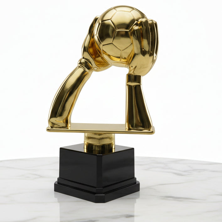 Gold trophy with a unique design on a wooden floor