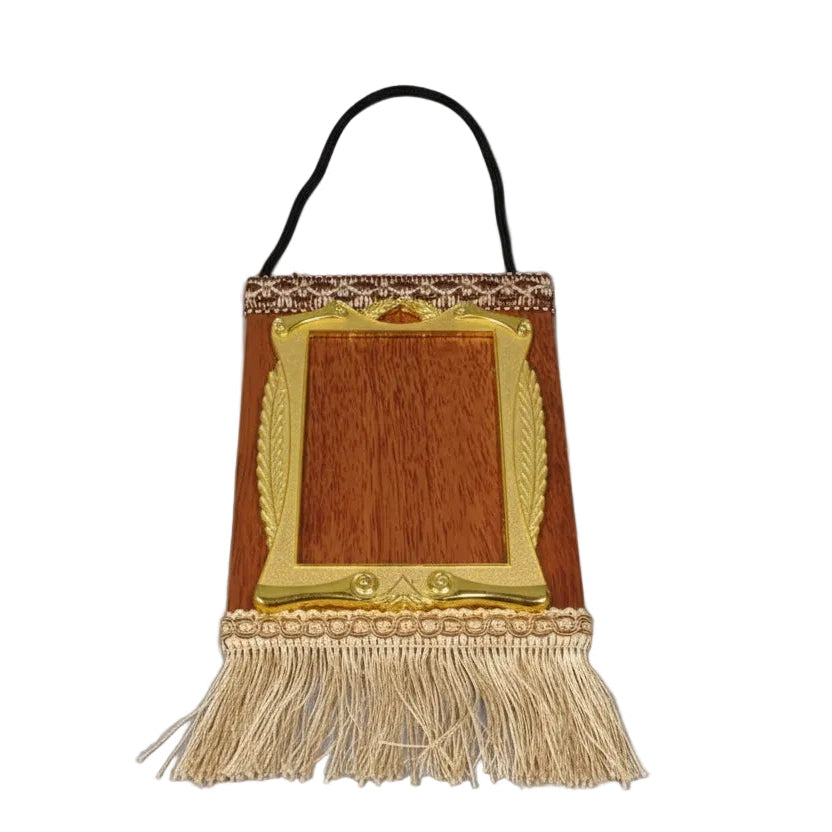 Decorative wooden panel with gold frame and tassels on a blue surface