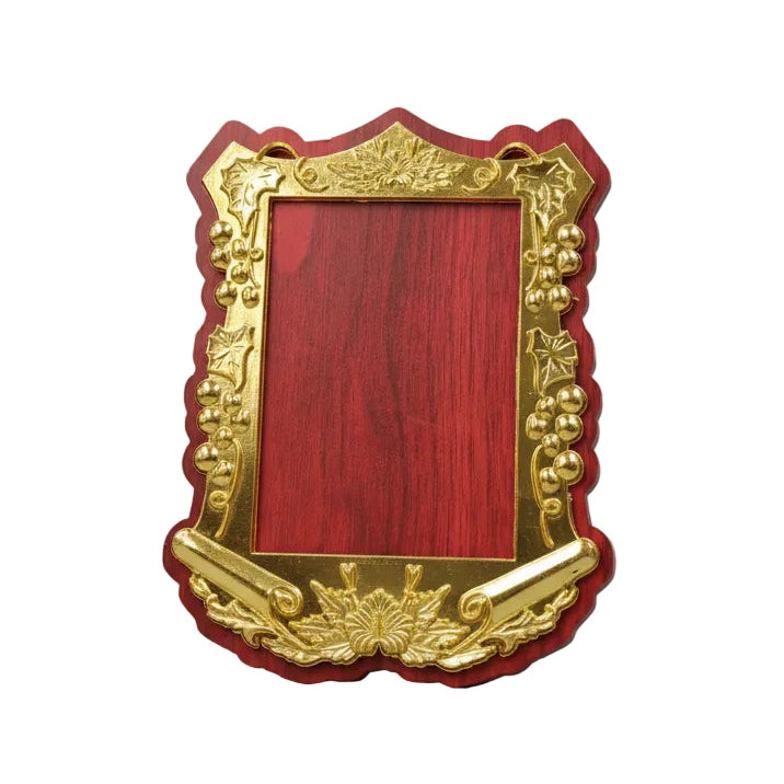 Decorative red and gold picture frame on a desk