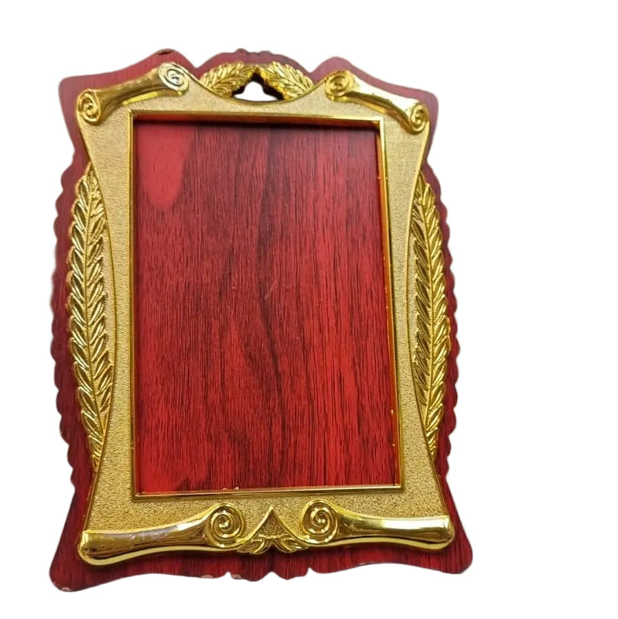 Decorative red and gold photo frame on a desk