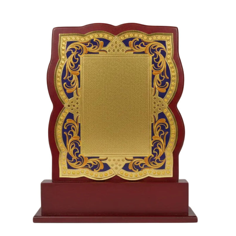 Decorative plaque with gold center and red frame on a white background